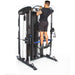 Bodycraft XFT Functional Trainer side with all white background with athlete doing pull ups with band assist