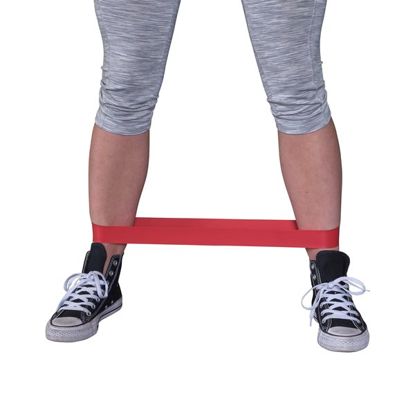 Female athlete exercising with a red resistance band around her ankles.