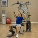 White male in a blue shirt performing chest press using individual cable handles from the multi-grip press arms on the Powerline by Body-Solid P2X Multi-Functional Home Gym.