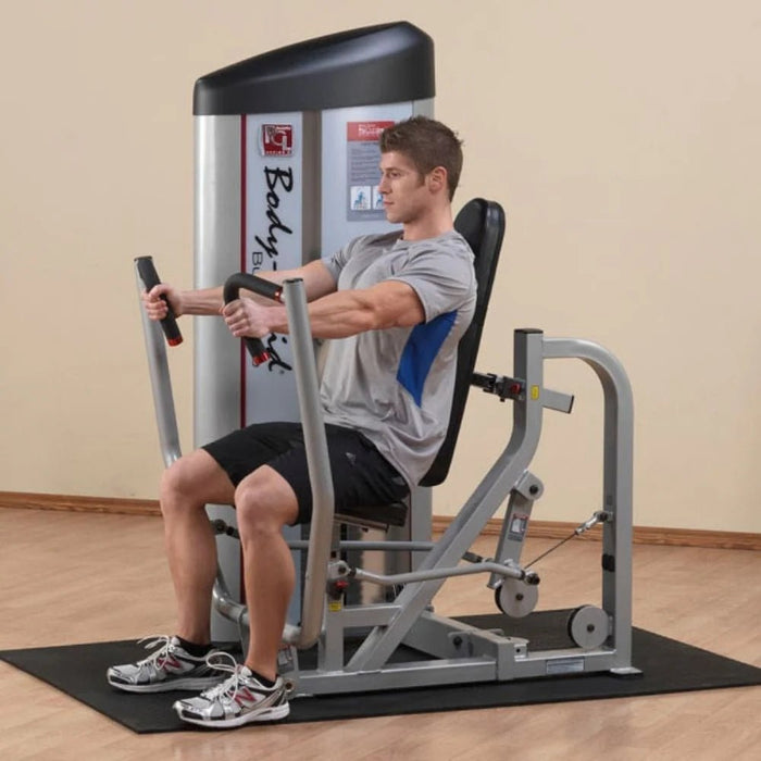 Athlete demonstrating the Body-Solid S2CP Chest Press Machine with arms fully extended, showcasing the multi-position hand grips and smooth pressing motion.