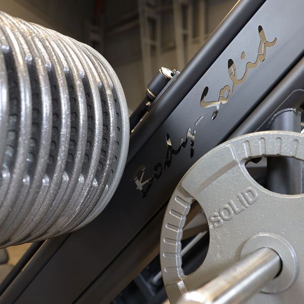 Close-up of the weight plates loaded onto the Body-Solid SGLP500 Leg Press, highlighting the Olympic weight horns and heavy-duty construction.