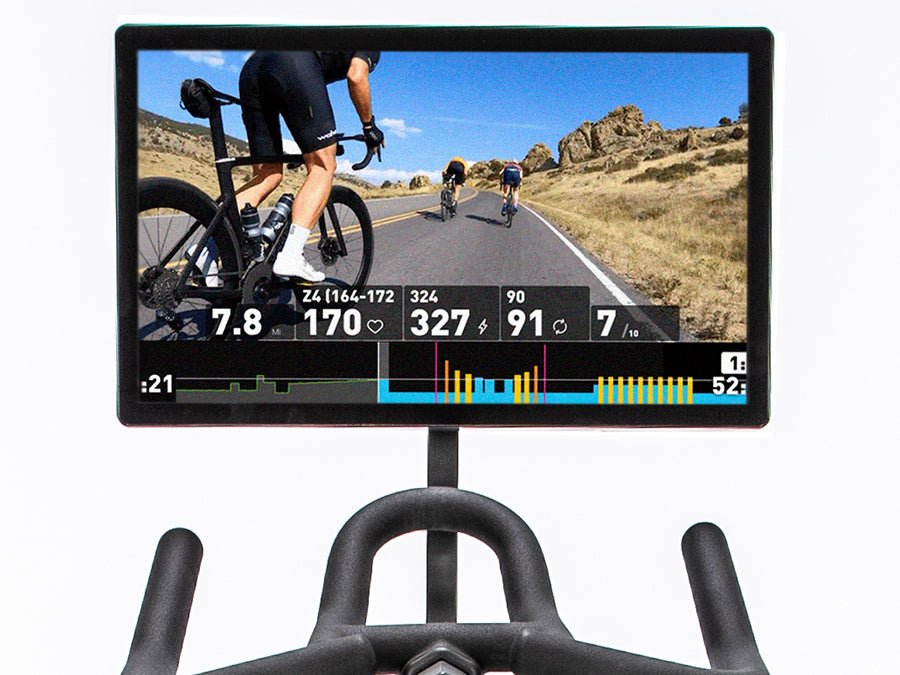 "Straight-on view of the Connect-22 tablet mounted on a BodyCraft indoor cycle, displaying a virtual road biking experience with athletes on screen, simulating biking within their group."