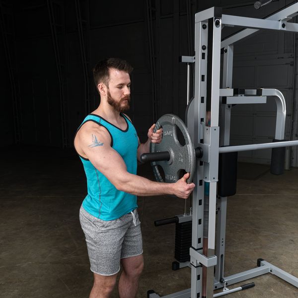 Powerline Smith Machine Package showing male athlete loading 2" olympic plates to the smith machine bar