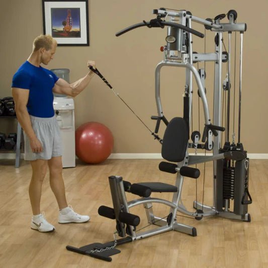 White male in a blue shirt performing a one-arm bicep curl using a cable attachment on the Powerline by Body-Solid P2X Multi-Functional Home Gym.