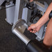 Close-up view of a user adjusting the leg extension pad on the Pro Clubline Leg Extension Leg Curl Combo Series II S2LEC, demonstrating the machine's adjustable settings for personalized comfort and optimal exercise positioning.