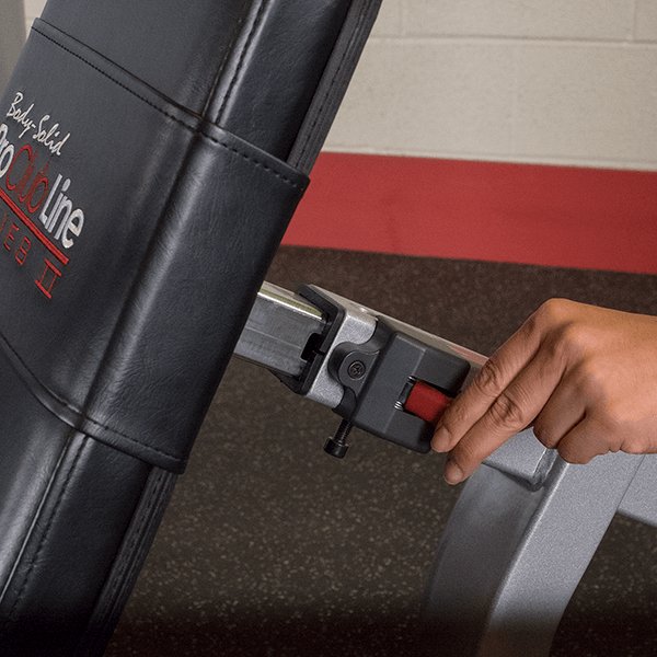 Close-up view showing the adjustability of the Pro Clubline Leg Extension Leg Curl Combo Series II S2LEC, with an athlete adjusting the back seat pad for optimal support and personalized workout comfort.