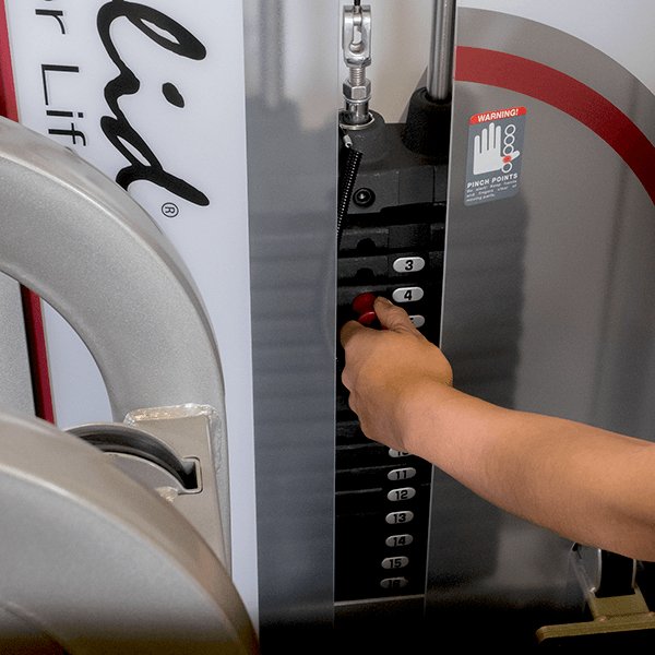 Close-up view of the weight stack on the Pro Clubline Leg Extension Leg Curl Combo Series II S2LEC, showing a user selecting the desired weight amount, with clear weight increments and an optional 235 lb. weight stack upgrade for customized resistance levels.