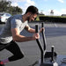 Close-up of a male athlete pushing the BodyKore Smart Sled Pro, highlighting the ergonomic handles and focused intensity of the workout.