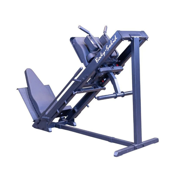 Body Solid Angled Leg Press & Hack Squat Machine side view on a white background looking from back to front showing handles and weight horns highlighting the quad track roller system, diamond plate foot platforms, and durable frame construction for effective lower-body exercises.