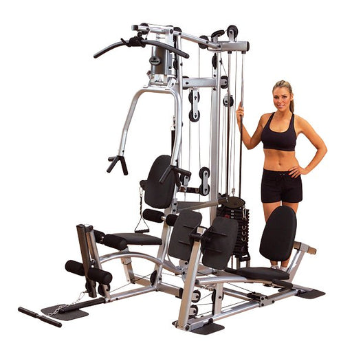 Female athlete performing a leg press on the Powerline by Body-Solid P2X Multi-Functional Home Gym with optional leg press attachment, standing and leaning into the machine.