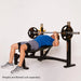 Athlete performing flat bench press on Powertec Workbench Olympic Bench WB-OB20.